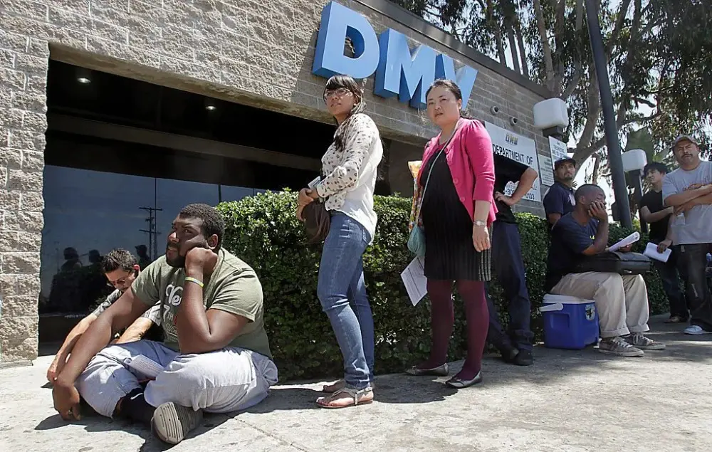 A group of people sitting on the ground outside.