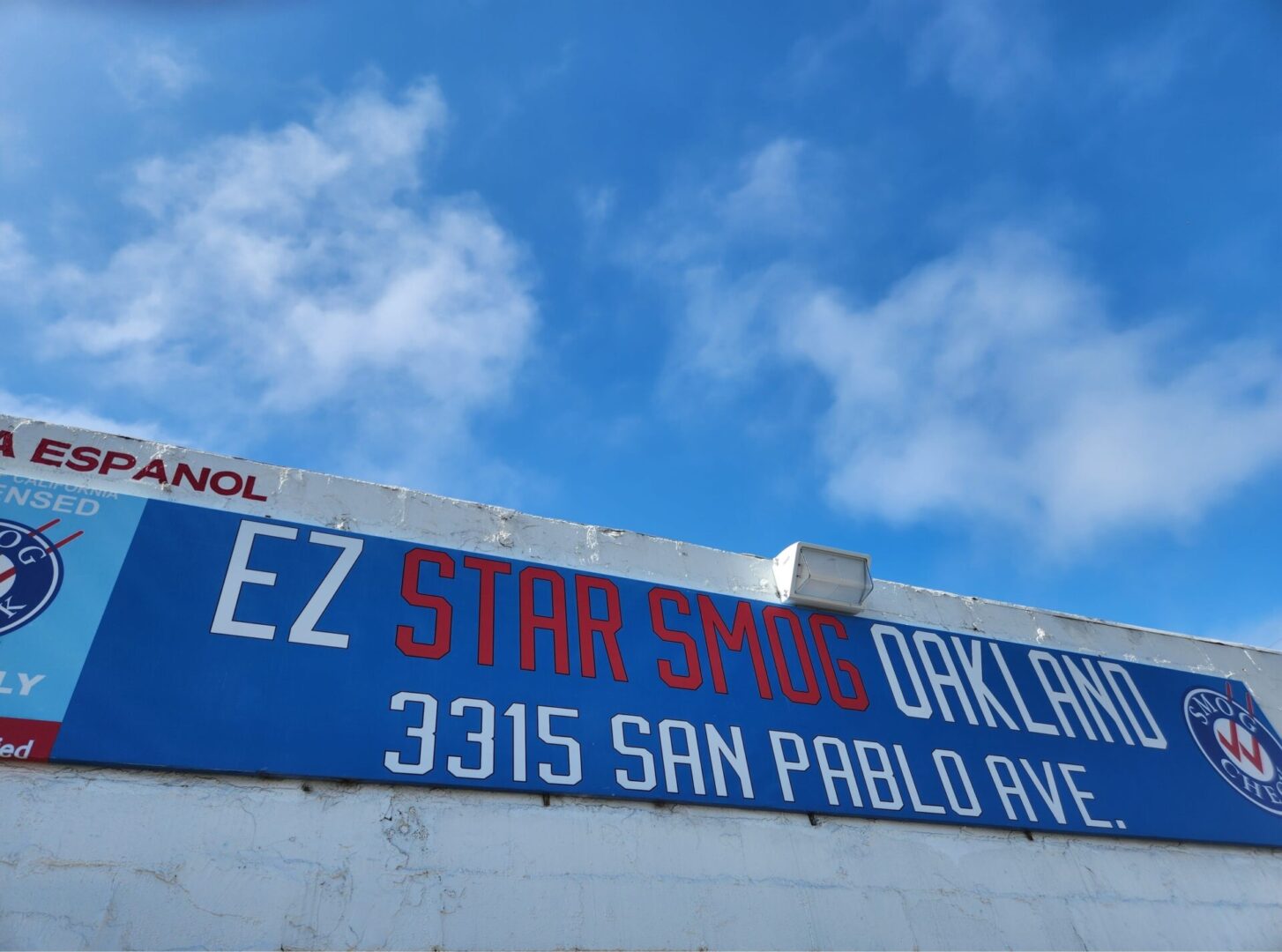 A blue sign on the side of a building.
